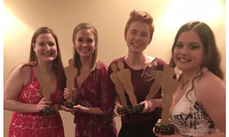 four women with awards