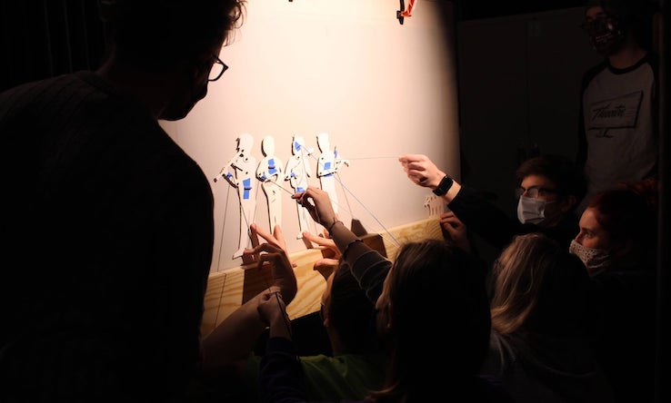students working puppets
