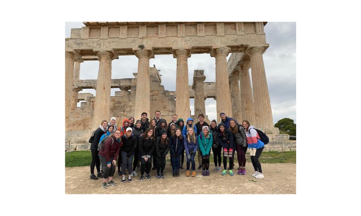 group of students in front of Grecian ruins