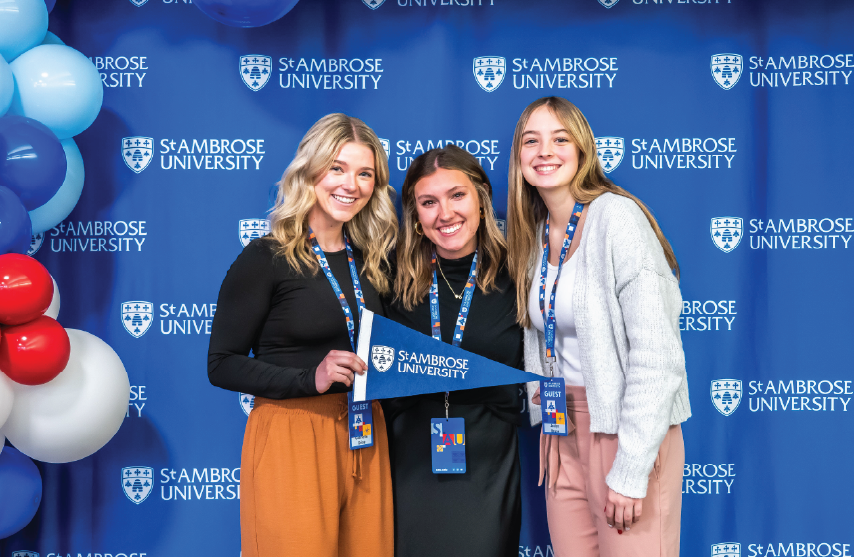 Three women posing for the camera at a visit event