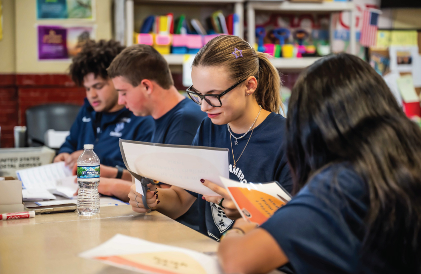 Group of students reading a piece of paper