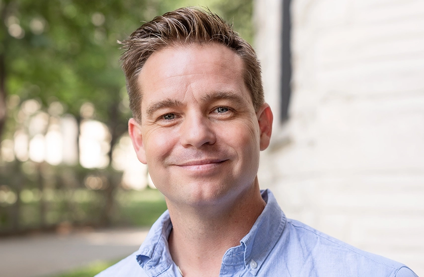 Adam McCormick, PhD, smiles into the camera.