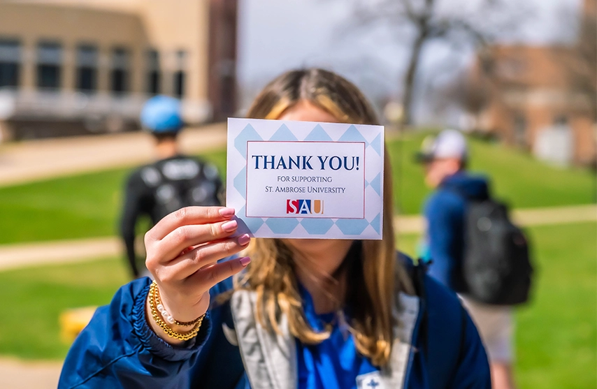 SAU Student holding thank you card
