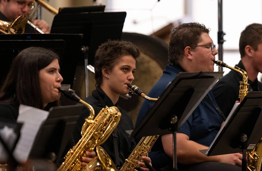 Students play instruments.