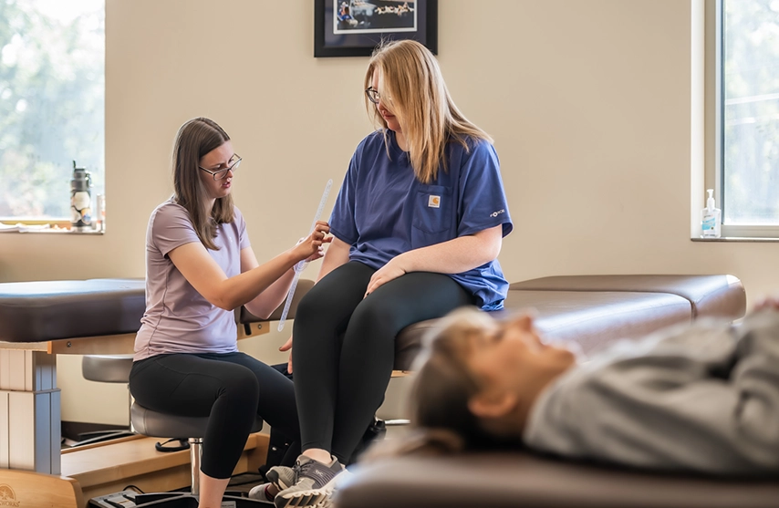 Three students work together during an OTD movement assessment at St. Ambrose University.
