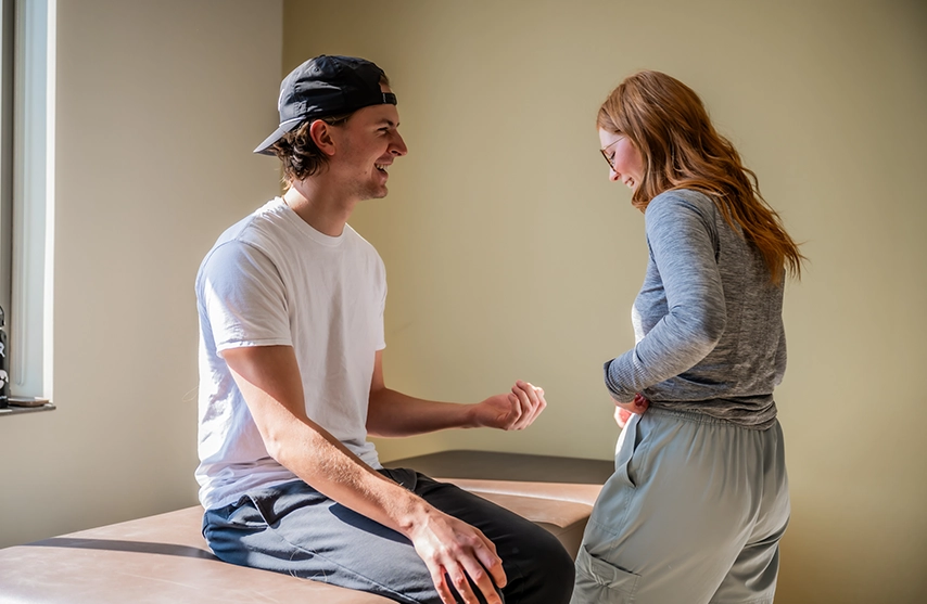 Two students work together during a movement assessment at St. Ambrose University.