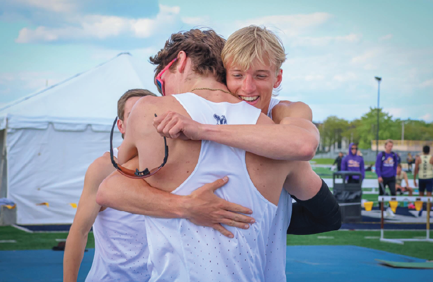 two cross country runners hugging