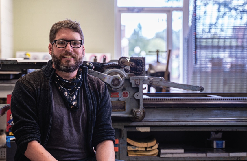 Joseph Lappie posing in the art studio.