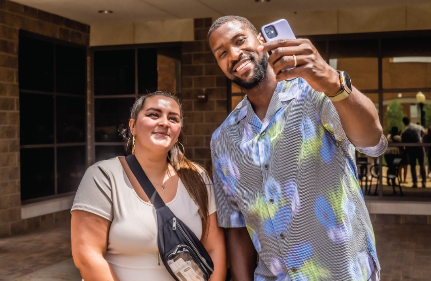 A man taking a selfie with a woman.