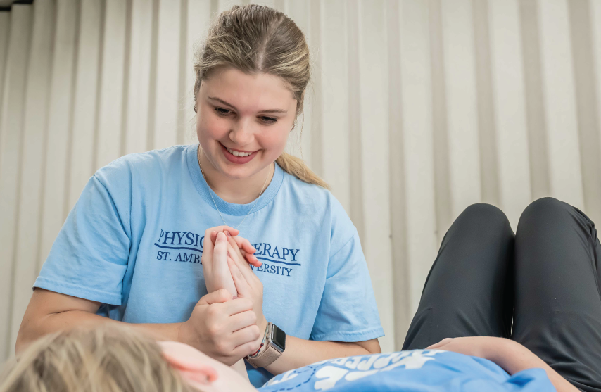Physical therapy student working with patient during clinical.
