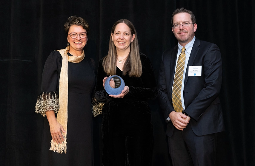 President Amy Novak stands next to an award recipient.