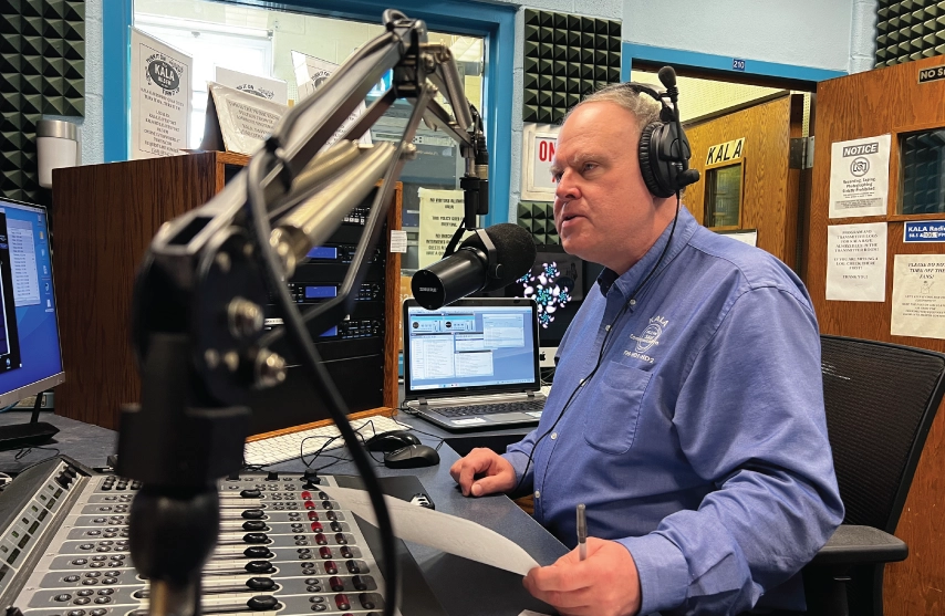 Dave baker in front of a microphone in a studio.