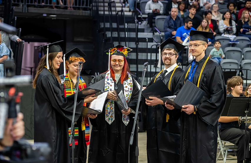 A group of graduating singers sing at their commencement ceremony.