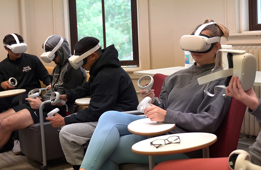 A group of students utilize VR headsets in the classroom.