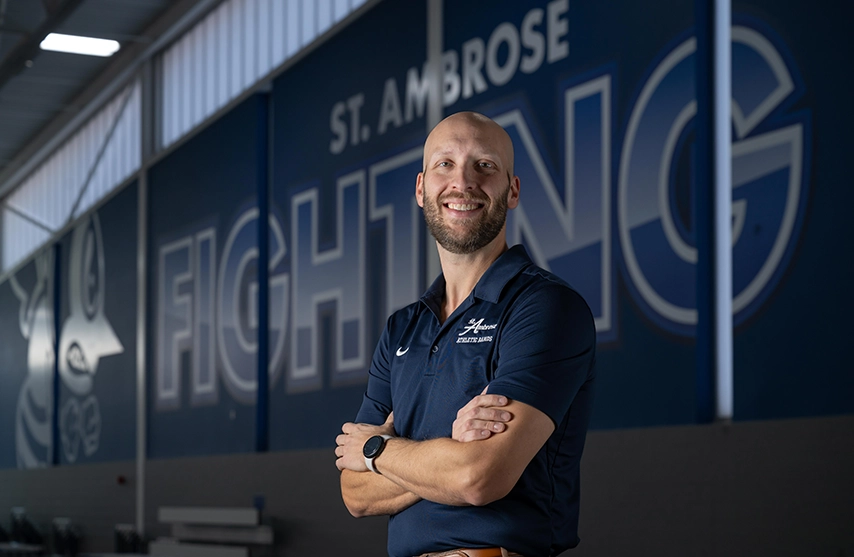 Fighting Bee Marching Band director Matthew Winarski, DMA, poses inside the Wellness and Recreation Center at St. Ambrose University.