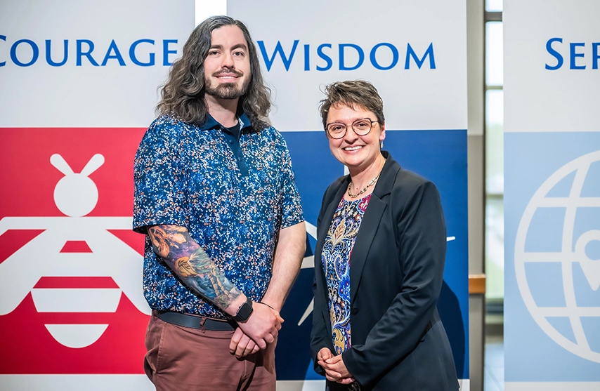 Steven McConnell and Amy Novak, PhD smile into the camera.