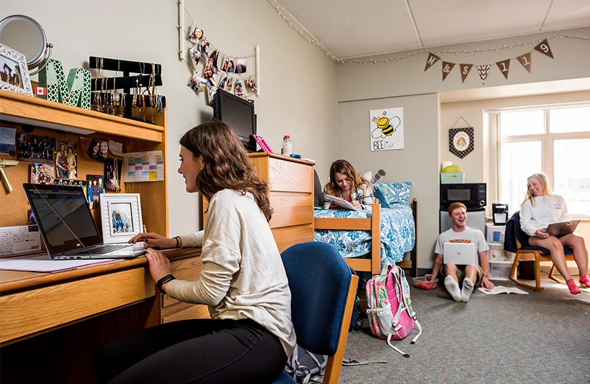 Four students work together in a St. Ambrose University residence hall.