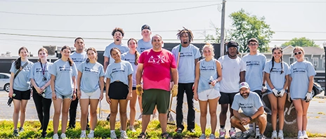 A group of first years smile at the camera after doing community service on BeeComing Ambrosian Day.