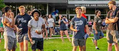 Students at St. Ambrose University play cornhole together during the annual block party.