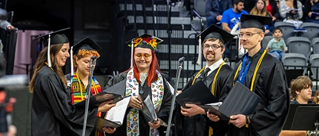 A group of graduating singers sing at their commencement ceremony.