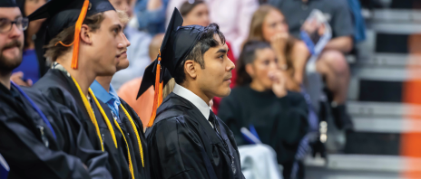 Jair Hernandez standing at commencement.