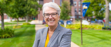 Mount Mercy Campus Board Chair LeAnn Ridgeway ’86, ’98 MBA poses outside on Mount Mercy University's campus.