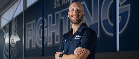 Fighting Bee Marching Band director Matthew Winarski, DMA, poses inside the Wellness and Recreation Center at St. Ambrose University.