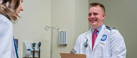 Two students practice medical care in the Master of Physician Assistant Studies program at St. Ambrose University.