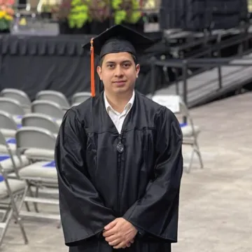 Headshot of Manuel Diaz wearing a cap and gown.